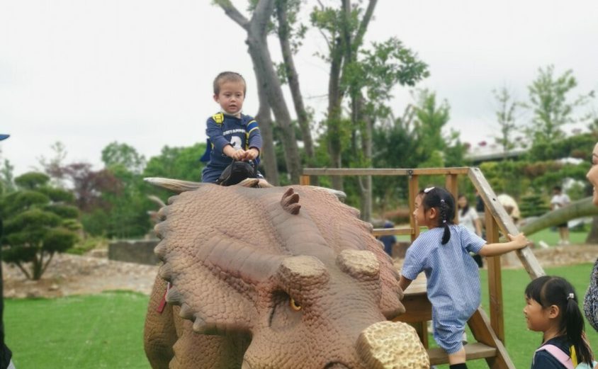 Luke rides a dinosaur